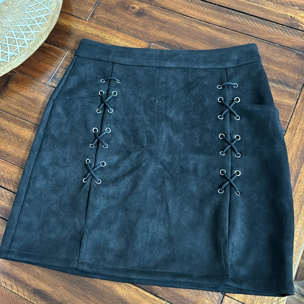 Black velvet type material skirt with lace up details and has little pockets!